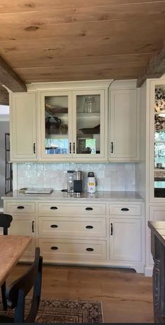 a kitchen with white cabinets and wood flooring is pictured in this image from the inside