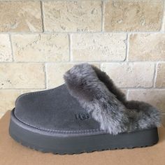 UGG DISQUETTE FLUFF SLIDE PLATFORM SLIPPER SHOES Color Charcoal / Dark Grey WOMEN SIZE US 6 Condition New without box Shipped with USPS Priority Mail. DESCRIPTION: •Suede upper • 10mm sheepskin lining gives a soft, plush feel. • 10mm sheepskin insole offers cushioning. • EVA outsole provides durability and traction. • 2" heel adds to your height. • • * RED PEN MARK ON SIZE TAG / BOX UPC TO PREVENT RETURN TO STORE FOR RETAIL PRICE** Grey Ugg Slippers, Grey Uggs, Grey Ugg, Dream Wishlist, Shoes For Me, 21 Birthday, Slides Slippers, Cool Backgrounds Wallpapers, Soft Slippers