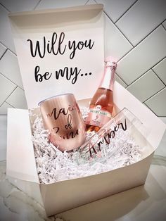 two wine glasses in a gift box that says, will you be my?