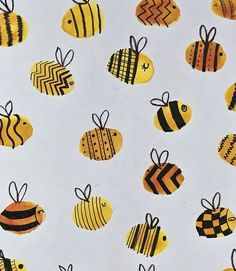 the bees are painted in yellow and black on a white background with chevron stripes