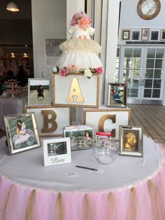 a table topped with pictures and framed photos