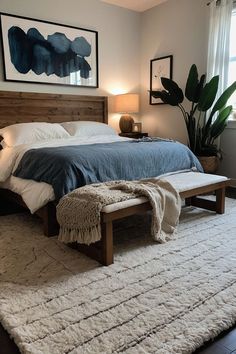 a bedroom with a large bed and rugs on the floor