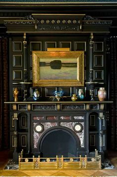 an ornate fireplace in a room with black walls