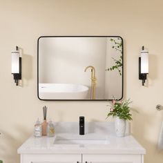 a bathroom with a sink, mirror and plants on the counter in front of it