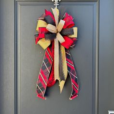 a red, yellow and black bow hanging on a door