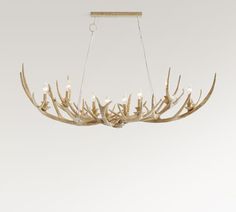 the antler chandelier is made from wood and has white lights on it