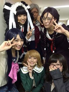 group of young women posing for the camera with their fingers up in front of them