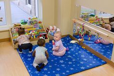 three children playing with toys in a play room