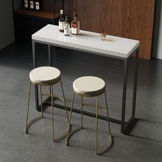 two stools sitting at a table with bottles on it