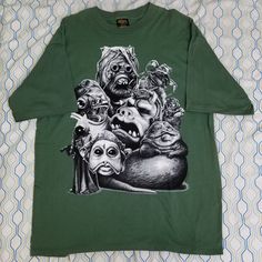 a green t - shirt with an image of monsters on it