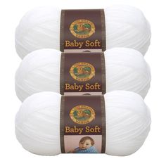 three balls of baby soft yarn in white