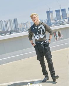 a young man standing on top of a parking lot