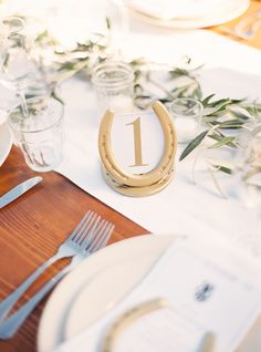 the table is set with plates and silverware