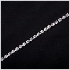 a diamond bracelet on a black background