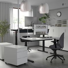 an office with two desks and chairs in it