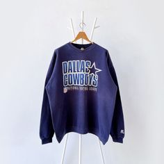 90s Dallas Cowboys NFL sweatshirt/ XL * PLEASE READ BEFORE PURCHASE * PLEASE consider the PHOTOS before making the decision * The images may DIFFER in appearance from the actual product because we took pictures under daylight.  * PLEASE send your PHONE NUMBER after your purchase for the shipping company to contact you X No returns X No refund Condition : 7/10 More details : faded color/ mottled (back)/ look at the pictures  Brand : Starter Size On Tag : XL Pit to pit/ Chests : 26/52 inches  Length : 29 inches  Material : cotton polyester  Color : blue  * ALL ITEMS are VINTAGE which may show some signs of wear and tear * Due to the different display and different light, the picture may not reflect the actual color of the item * Please, remember that our items are vintage so they may show so Fade Color, Dallas Cowboys, Dallas, Nfl, Cowboy, Sweat Shirt, Vintage Outfits, Gender Neutral, Sweatshirts Hoodie