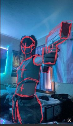 a man holding a nintendo wii game controller in front of his face with red neon lights