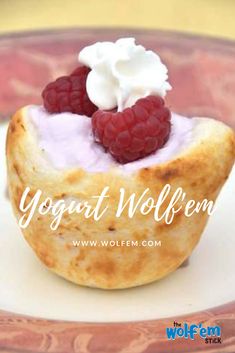 a small pastry with whipped cream and raspberries on top