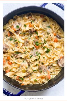 a skillet filled with pasta and mushrooms