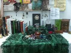 a table topped with lots of books and jewelry