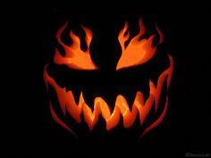 a scary pumpkin with flames on it's face