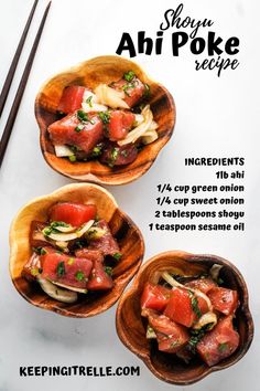 three wooden bowls filled with food on top of a white table next to chopsticks