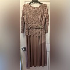 a dress hanging on a hanger in front of a door