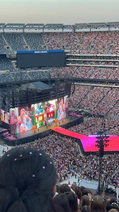 a large crowd at a concert in an arena