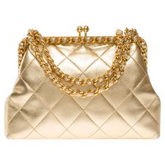 Extremely​ ​Rare​ ​Chanel​ ​shoulder​ ​bag​ ​in​ ​metallic​ ​gold​ ​quilted​ ​leather,​ ​gold​ ​metal​ ​trim,​ ​golden​ ​metal​ ​handle​ ​interlaced​ ​with​ ​gold​ ​leather​ ​for​ ​carrying​ ​hand​ ​or​ ​shoulder​ ​or​ ​crossbody​ ​carry Mechanical​ ​opening​ ​by​ ​golden​ ​metal​ ​balls Metallic​ ​gold​ ​leather​ ​interior​ ​lining,​ ​one​ ​zippered​ ​pocket Signature:​ ​"Chanel®Made​ ​in​ ​Italy" Date:​ ​1994/1996 Dimensions:​ ​18x12x5​ ​cm​ ​(7,1x4,7x2​ ​Inches) Chain​ ​length:​ ​57​ ​cm​ ​(22.5​ ​Inches) Reference:​ ​101986 General​ ​condition:​ ​7.5/10 Sold​ ​with​ ​hologram​ ​and​ ​authenticity​ ​card In​ ​excellent​ ​vintage​ ​condition​ ​despite​ ​minor​ ​wear​ ​marks​ ​on​ ​leather​ ​(scratches,​ ​patina),​ ​interior​ ​(wear)​ ​and​ ​trim​ ​(scratches) Vintage Chanel Bag, Structured Shoulder, Chanel Brand, Chanel Shoulder Bag, Togo Leather, Metal Trim, Handbag Straps, Quilted Leather, Vintage Chanel