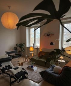 a living room filled with lots of furniture next to large windows and floor lamps on either side of the window