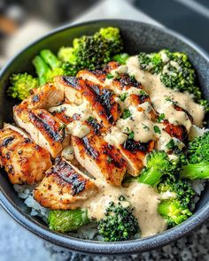 a bowl filled with chicken, broccoli and rice