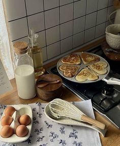 some food is sitting on a table with utensils and other items next to it