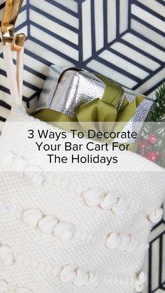 a white sweater hanging on a hook with the words 3 ways to decorate your bar cart for the holidays