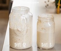 two jars with different types of food in them sitting on a counter next to each other