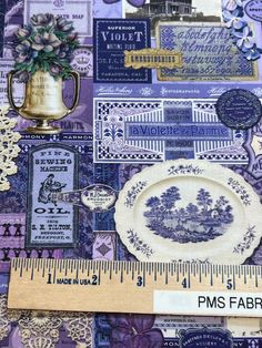 a ruler is next to a wall covered in blue and purple fabric with various items on it