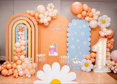 an image of a birthday party setting with balloons and flowers on the table for decorations