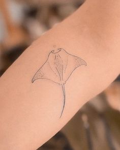 a woman's arm with a tattoo of a flower on the back of it