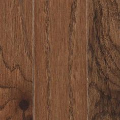 a close up view of the wood grains on this hardwood flooring project, with dark brown stain