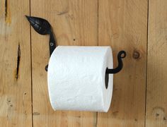 a toilet paper roll hanging on a wooden wall