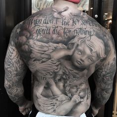 the back of a man with tattoos on his body