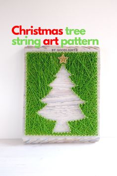 a christmas tree string art pattern is displayed on a white surface with green grass in the background