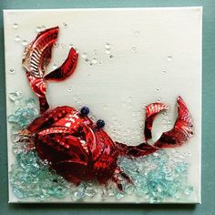 a red glass crab sitting on top of some blue water and bubbles in the background