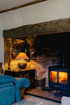 a living room with a fire place next to a bed