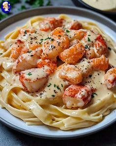 a plate of pasta with shrimp and cream sauce