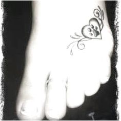 a person's foot with a tattoo on it and a butterfly flying over them