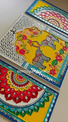 three colorfully painted cards with elephants on them