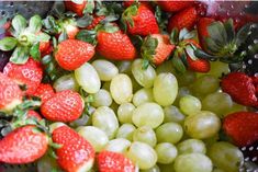 grapes and strawberries are mixed together in a bowl