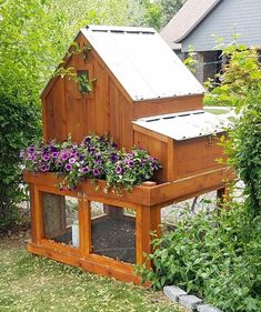 a chicken coop with flowers growing in it