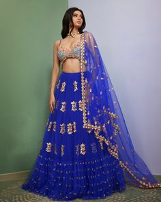 Introducing Artworq, a stunning iris blue lehenga designed to make you feel like royalty on your special day. Exquisitly crafted from a soft tulle base and embellished with shimmering glass crystals and intricate glass-cut beaded embroidery. The matching blouse features a stylish and modern cut, the piece comes with a matching dupatta, adorned with glass crystals and glass-cut beaded embroidery. From Papa Don’t Preach’s Capsule collection. DELIVERY TIMEPlease allow 8-12 weeks for your outfit to Papa Don't Preach, Blouse Yoke, Shirt Jacket Men, Blue Lehenga, Drape Saree, Soft Tulle, Lehenga Designs, Silk Roses, Dress Suits