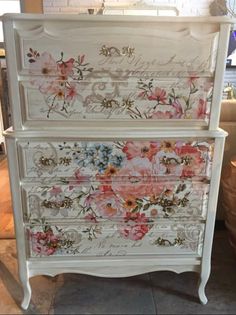 an old dresser with flowers painted on it